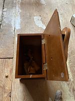 Open wooden shoeshine box interior