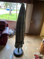 Folded patio umbrella on base
