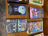 E.T., Fantasia, Expo 86 and Toy Story VHS tapes on table