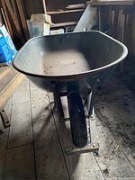 Side view of steel wheelbarrow with single front wheel