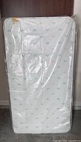 Sealed Kolcraft crib mattress front view