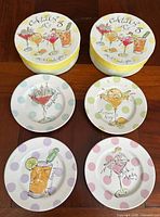 Two round boxes and four sample plates displayed