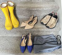 All four shoe pairs and shoe bag on stairs