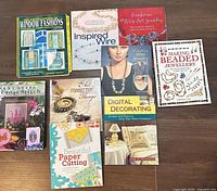 All eight crafting books laid out on floor showing front covers