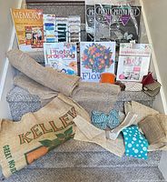 Overall view of books, fibers, felt packs, burlap fabrics and ribbons spread on stairs