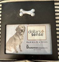 Front view of black frame showing silver bone ornament and size insert