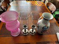 Group shot of pink vase, two hurricane holders, floral vase