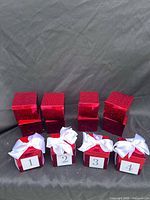 Full set of twelve red glitter gift boxes, four with ribbons and numbers