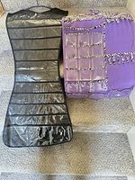 Front view of black organizer with clear pockets and front view of purple organizer with clear pockets