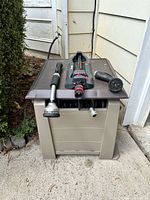 Hose caddy with attachments on lid