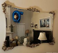 Full view of ornate mirror hung on wall