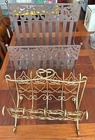 Brown cut-out floral rack front with gold rack in foreground