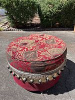 Full view of round ottoman showing upholstery pattern and shape