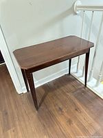 Full view of table showing shape, finish and legs