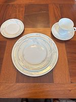 One complete place setting displayed on wooden table