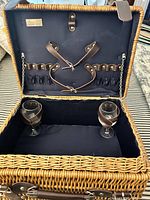 Open basket showing interior straps, lining, two wine glasses