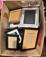 Top-down view of box containing assorted picture frames