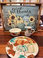 Wall art and one place setting displayed on table