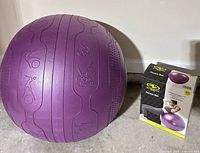 purple fitness ball beside retail box