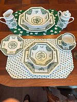 Full place settings, serving pieces, goblets and placemats on table