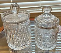 Both cut crystal biscuit jars with lids displayed