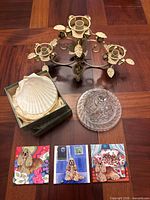 Overview of entire lot: candelabra, tiles, butter dish, box of scallop shells