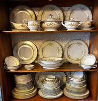 Full cabinet view showing majority of plates, bowls, serving pieces