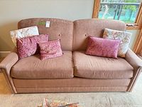 Front view of sofa bed with five pillows