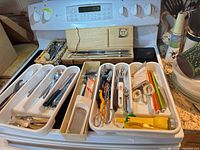 Overview of trays, knife box and utensils on stovetop