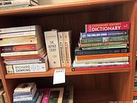Overall view of shelf showing majority of book lot