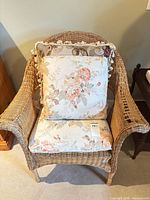 Front view of wicker armchair with floral cushions