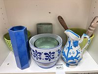 All six ceramic items grouped on shelf
