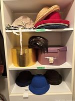 Shelf view showing six hats and two hat boxes