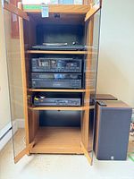 Full view of cabinet with all components and one speaker visible