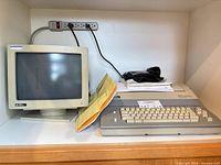 Main unit, CRT monitor, paperwork on shelf