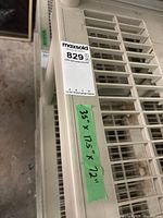 Top corner of resin shelving showing label and slatted shelf design