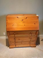 Front view of closed drop-front pine secretary desk