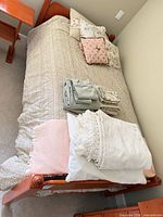 Overall view of twin bed with bedding and pillows