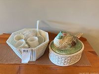 Full view of punch bowl set with cups and ladle next to ceramic bird covered dish