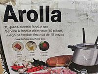 box front displaying Swissmar Arolla 10-piece electric fondue set imagery and text