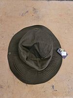 Top view of green safari hat showing brim and exterior tag
