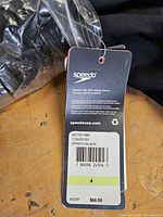 Retail hang tag showing brand, size 4, colour black, MSRP $68