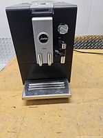 Front view showing Jura Ena 3 machine with drip tray and frother wand