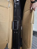 Folded solar panel in shipping box showing handle and frame