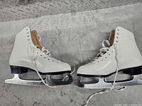 Full view pair white figure skates
