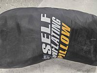 Black North49 stuff sack showing “SELF INFLATING PILLOW” text