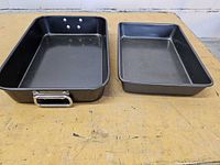 Two rectangular non-stick oven pans on table