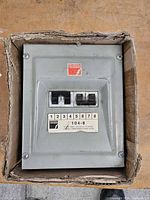 Front view of breaker panel showing logo, model label and installed breakers