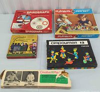 Overall lot view showing five boxed toys