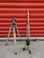 Goodman full-size tripod assembled beside Optex mini tripod and collapsed leg section